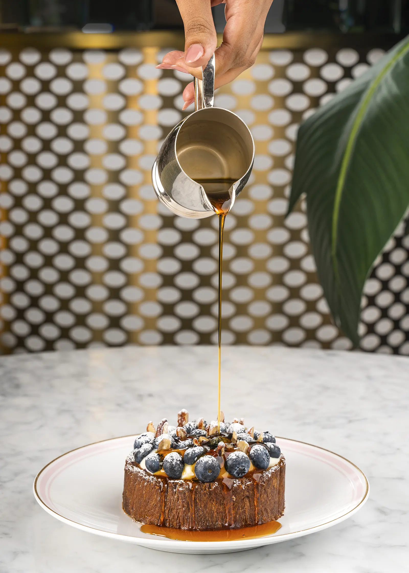 A plate of French toast topped with blueberries and nuts.