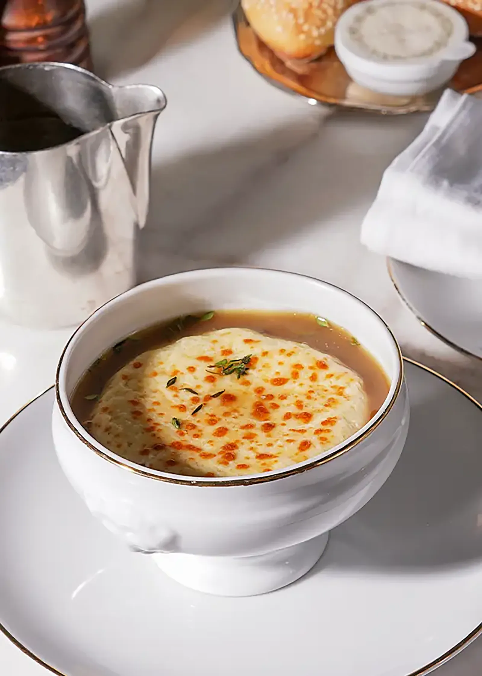 A bowl of French onion soup with melted Gruyère cheese.