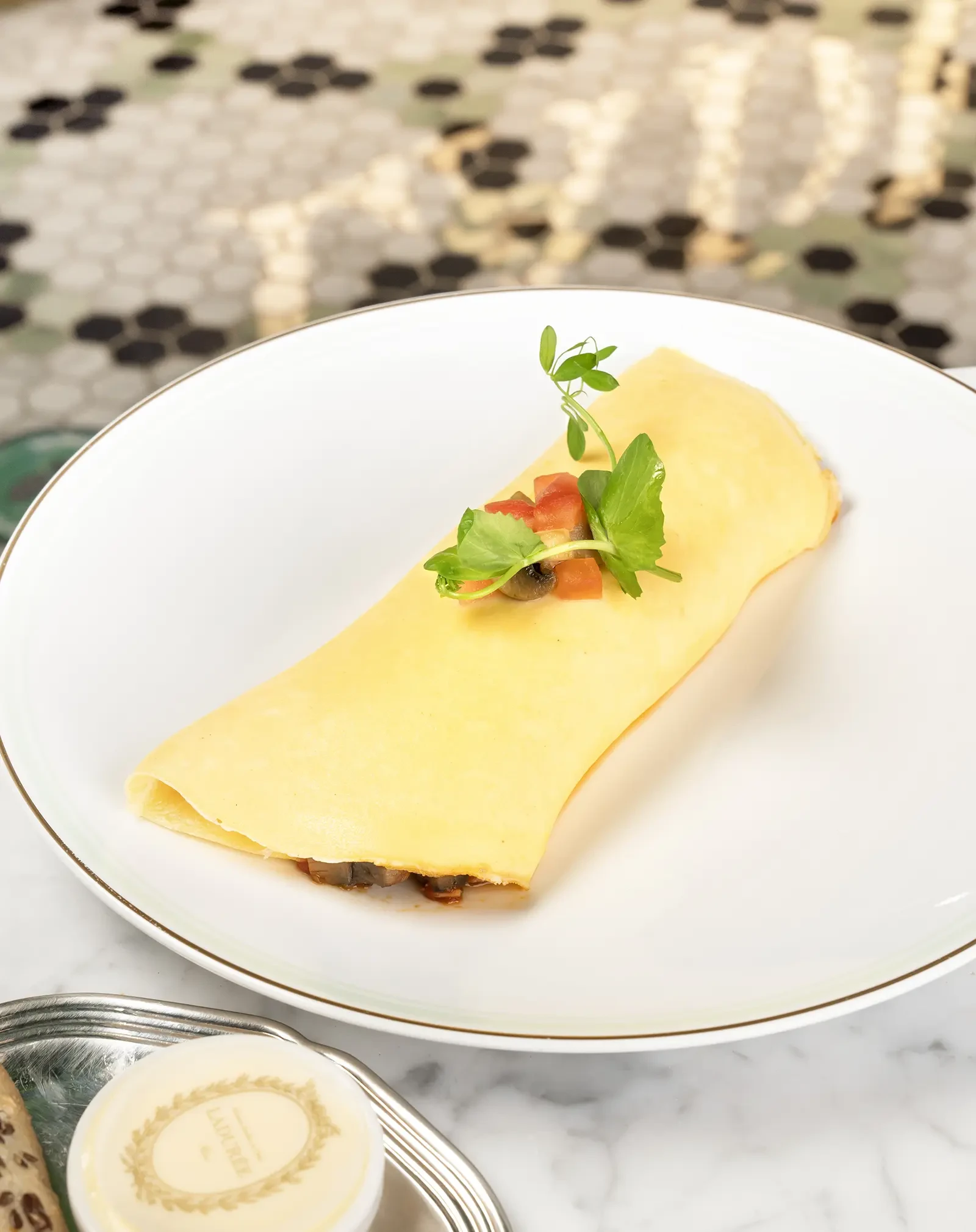 A fluffy omelet on a plate.