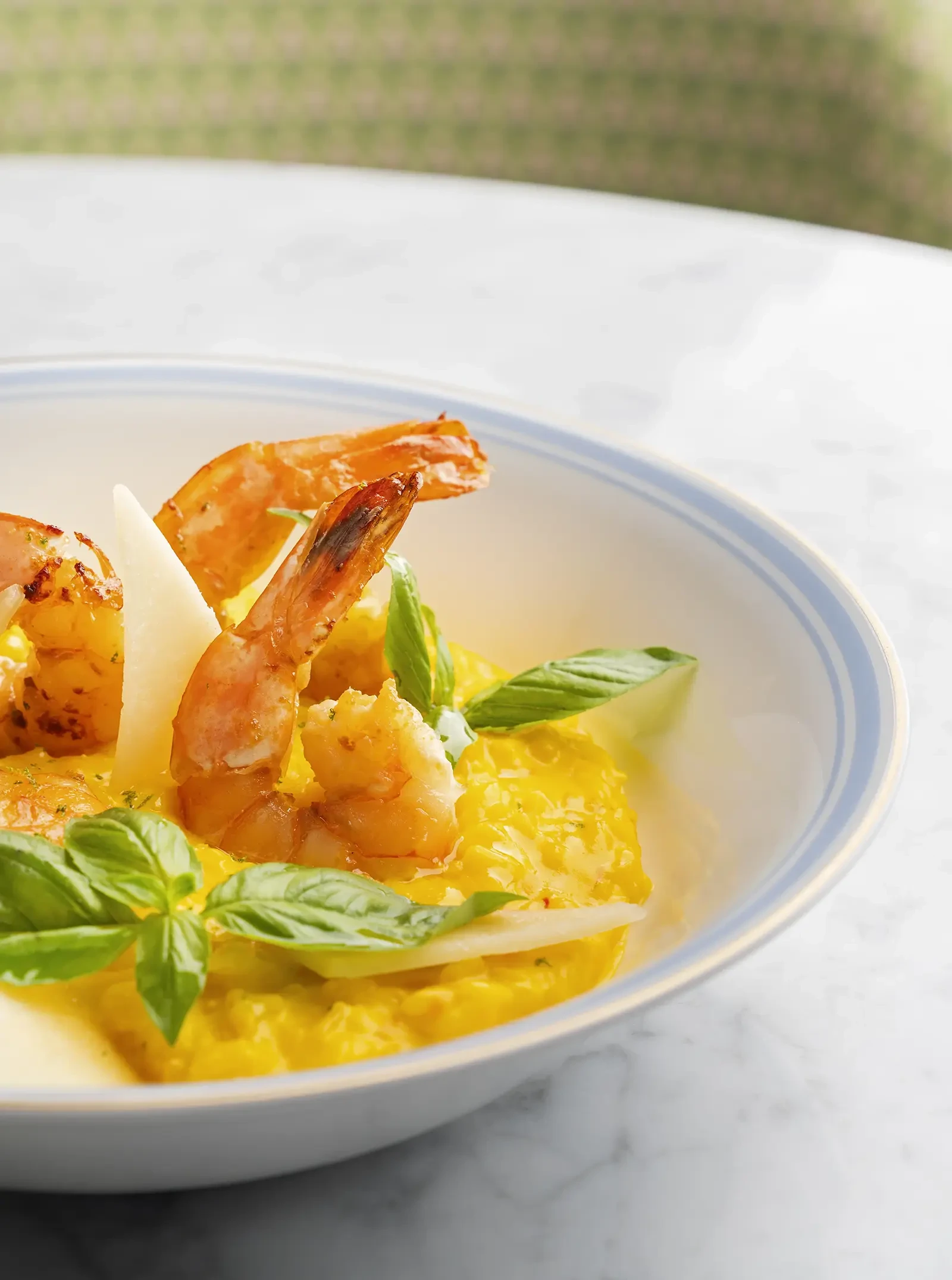 A bowl of golden saffron risotto with prawns.