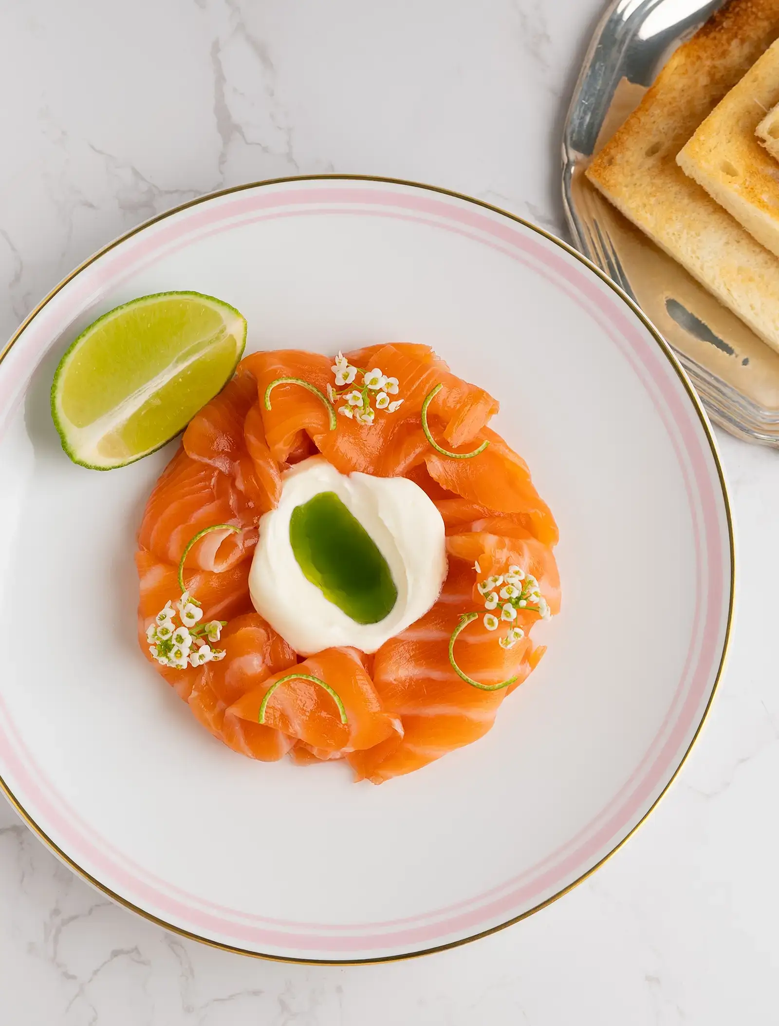 A plate of blinis topped with smoked salmon.