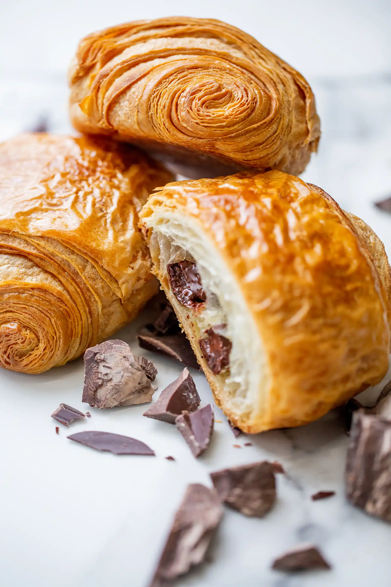 A small croissant with chocolate sticks inside.