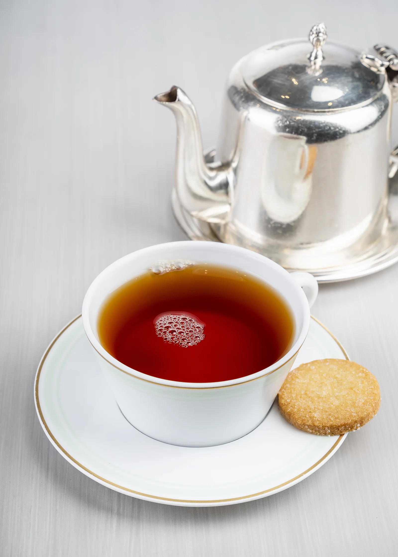A teacup and saucer filled with hot Earl Grey tea.