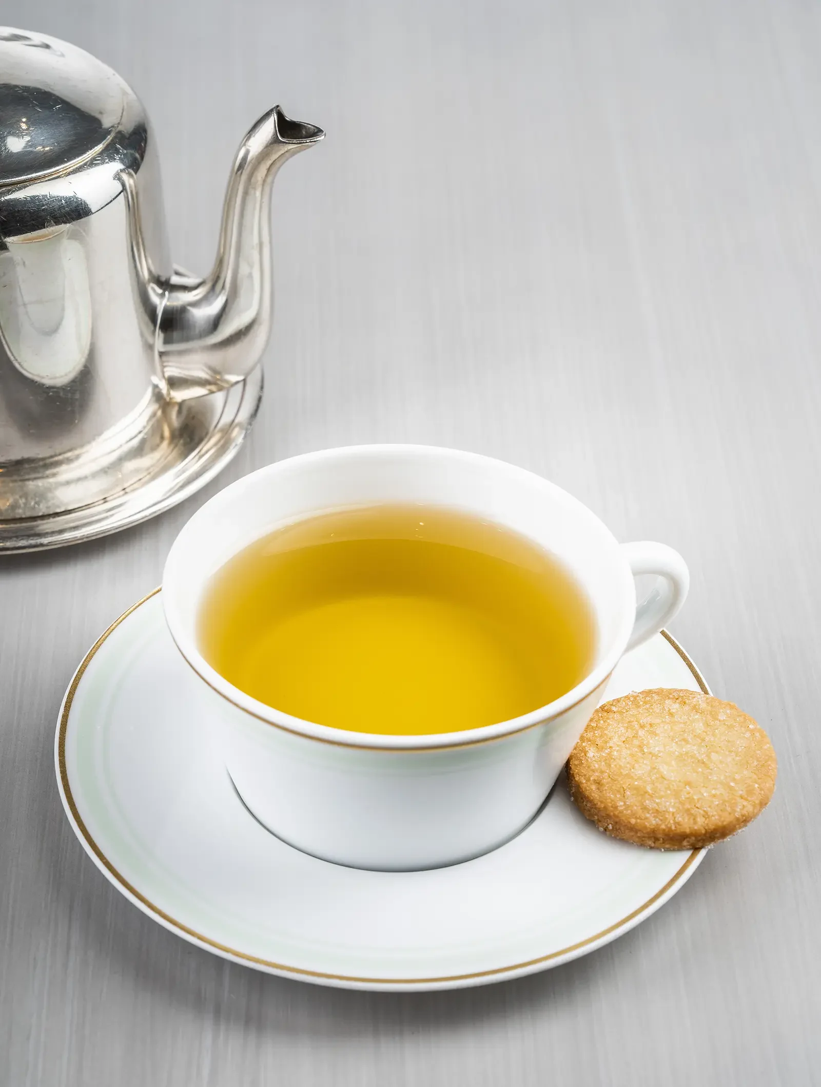 A teacup with Jardin Bleu Royal tea, a fruity and floral blend.