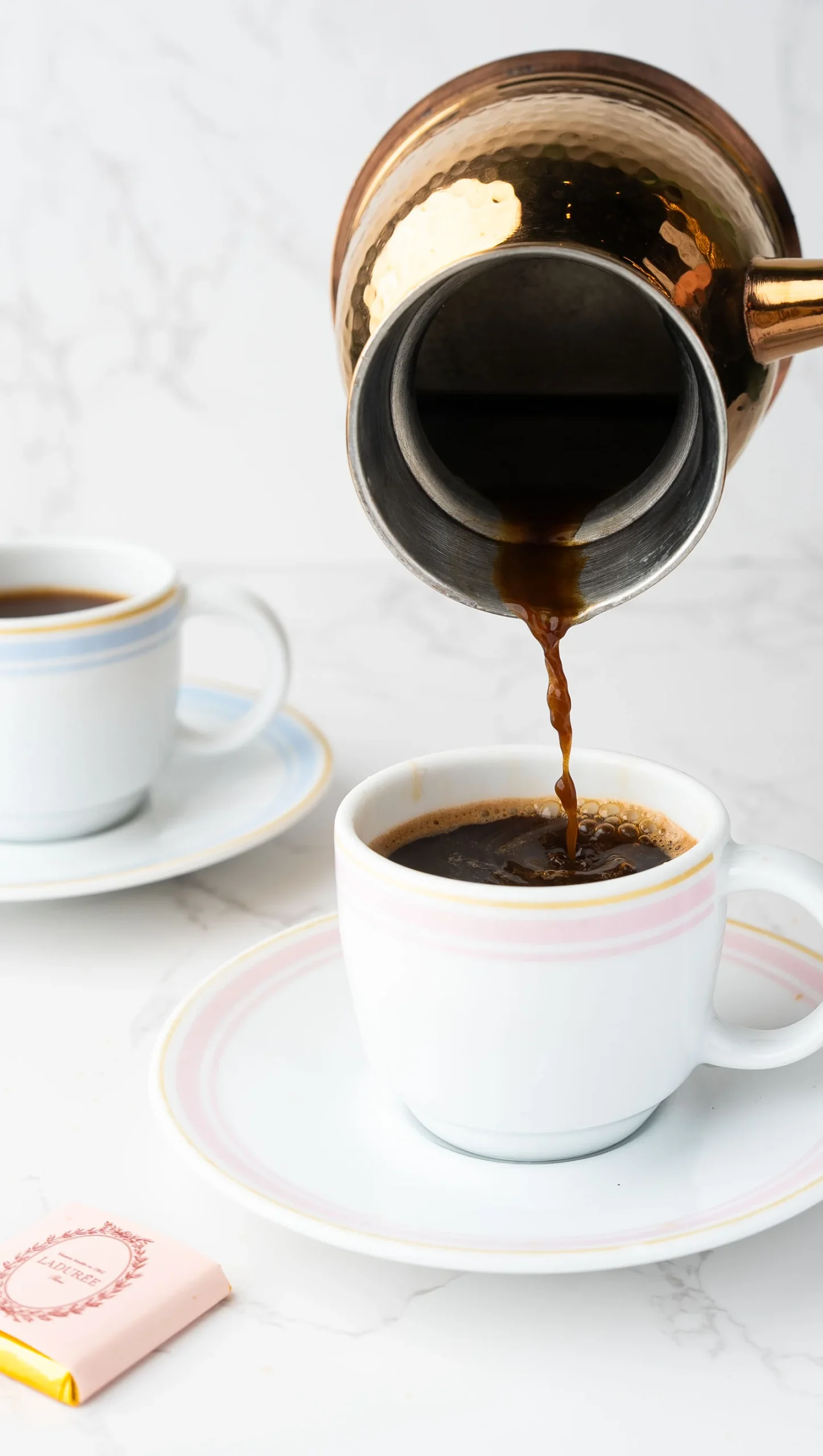 A small cup of Turkish coffee with a fine foam layer.